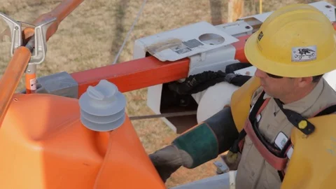 Electrical Lineman Working On Power lines on Utility Pole Stock Footage 124245216
