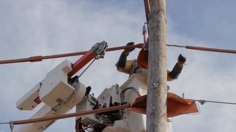 Electrical Lineman Working On Power lines on Utility Pole Stock Footage 124245218