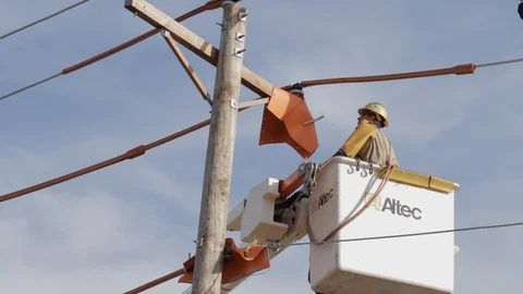 Electrical Lineman Working On Power lines on Utility Pole Stock Footage 124245223