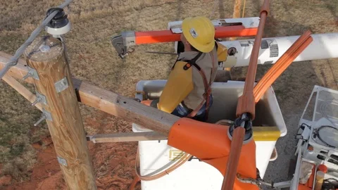 Electrical Lineman Working On Power lines on Utility Pole Stock Footage 124245224