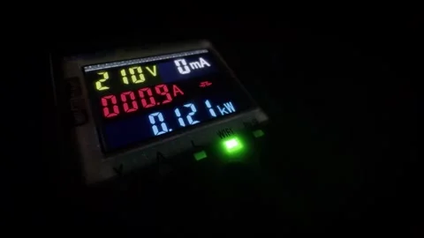 Electrical measuring device with colorful display showing voltage and power.. Stock Footage 337221876