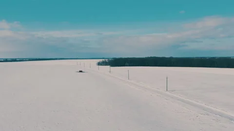 The electrical network is laid along the winter field Stock-Footage 148949143