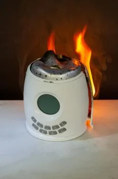 Electrical night projector overheating with flames and thick smoke showing da Stock Photos