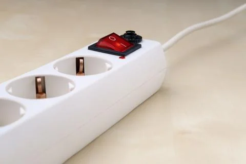 The electrical outlet is on a light colored surface. Stock Photos