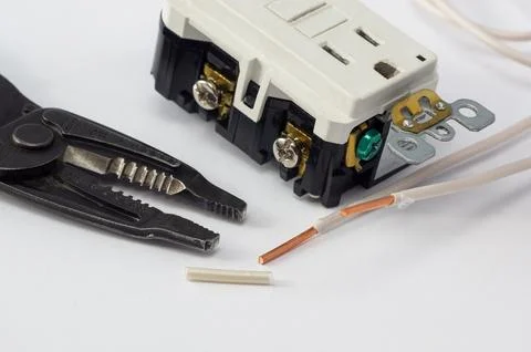 Electrical outlet, screwdriver and wire stripper tools on white background Foto stock