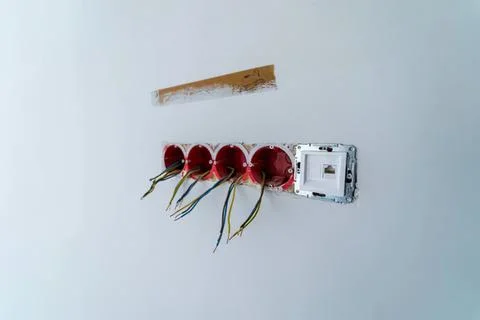 Electrical outlets with wires on a white wall Stock Photos