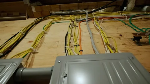Electrical panel and laid wires in new wooden home construction Close up Video stock 205250226