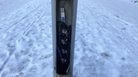 The electrical panel in a lamp post on the street is open in winter, light .. Stock Footage 302099041