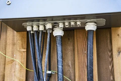 Electrical panels and electrical cables connected to them on the wall 库存照片