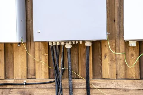 Electrical panels and electrical cables connected to them on the wall Stock-Fotos