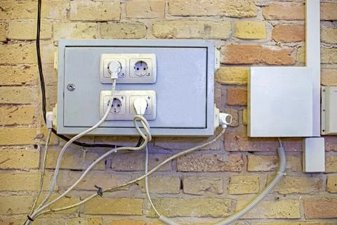 Electrical panels on an antique brick wall with numbered outlets Stock Photos