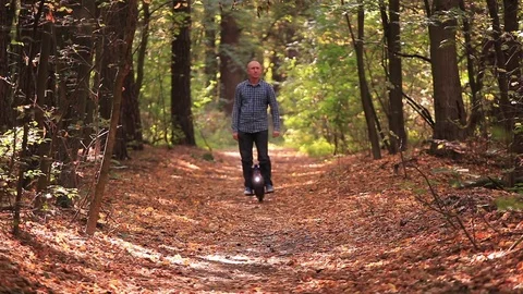 Electrical personal transport. Man riding mono wheel in autumn park road. Stock Footage