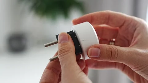 Electrical plug adapters with different socket standards in human hands Stock-Footage 346397401