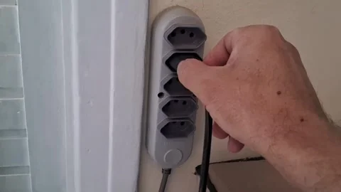 Electrical plug insertion into wall outlet power strip motion video clip Stock-Footage 339505066