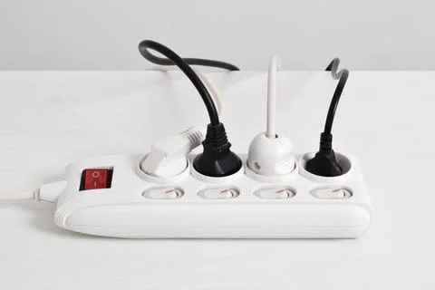 Electrical plug in outlet socket at home isolated on white background Stock Photos