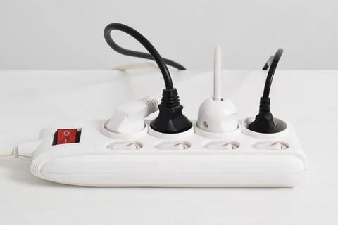 Electrical plug in outlet socket at home isolated on white background Stock Photos