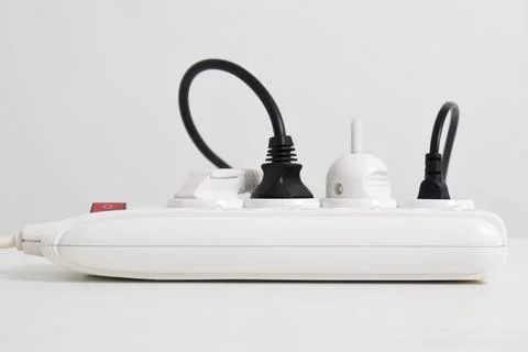 Electrical plug in outlet socket at home isolated on white background Stock Photos