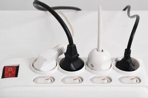 Electrical plug in outlet socket at home isolated on white background Stock Photos