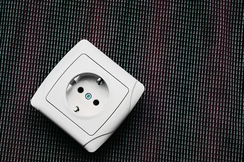 Electrical plug socket for connecting devices on red gray Stock Photos