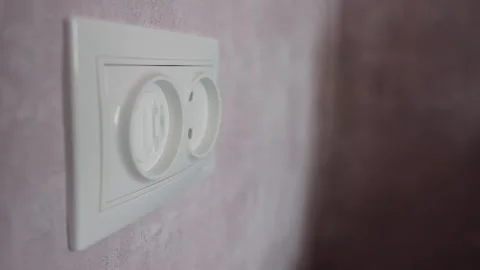 Electrical plug in the socket to protect children from electric shock, close-up Stock Footage 254062091
