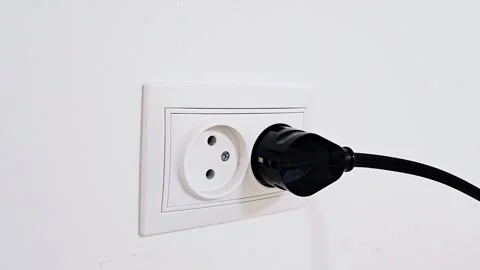 Electrical plug in the socket to protect children from electric shock, close-up Stock Footage 257349976
