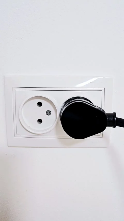 Electrical plug in the socket to protect children from electric shock, close-up Stock Footage 257351292