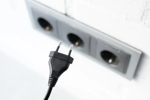 Electrical plug into wall outlet Foto stock