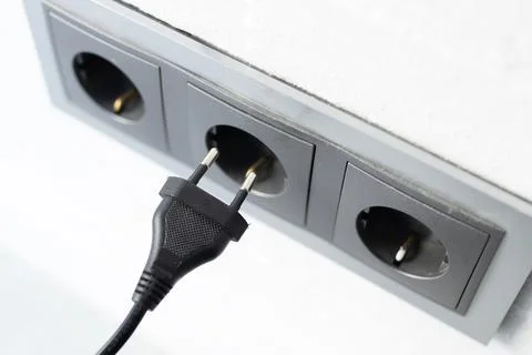 Electrical plug in wall socket 스톡 사진
