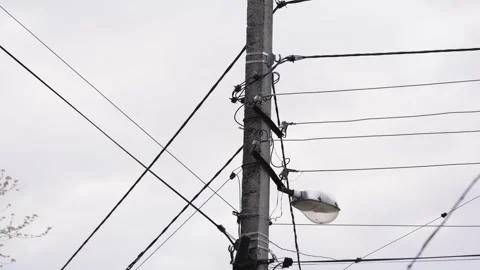 An electrical pole with multiple wires captured on a cloudy day. Stock Footage 240285202