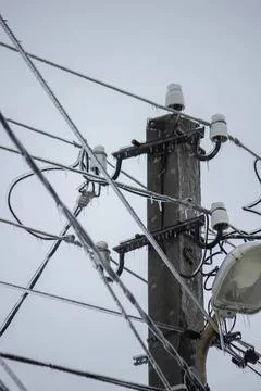 Electrical pole with wires and transformers against sky Stock Photos