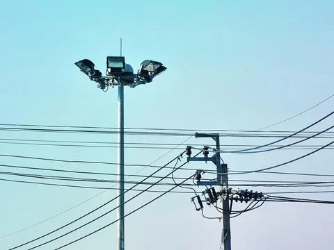 Electrical Post and Power Lines Against Clear Blue Sky Stock-Fotos