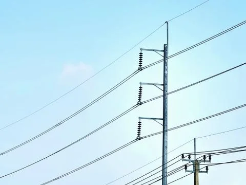Electrical Power Cables and Posts Against Clear Blue Sky Stock-Fotos