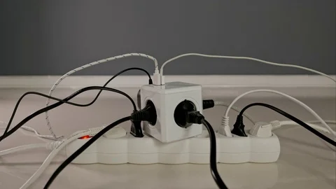 Electrical power extension on the floor, overfilled with power cords and cables. Video stock 76456436