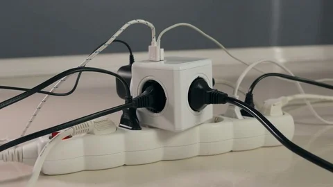 Electrical power extension on the floor, overfilled with power cords and cables. Stock-Footage 76456570