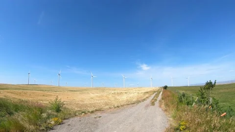 Electrical power-generating windmills  in the foothills of the Rocky Mountains Video stock 152991330