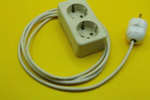 Electrical power plug on a yellow background, closeup of photo Stock Photos