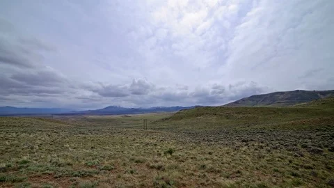 Electrical power in remote empy sagebrush field with power lines Stock Footage 81661921