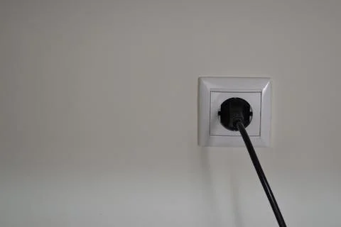 Electrical power socket and single plug black cable switched on, isolated on Stock Photos