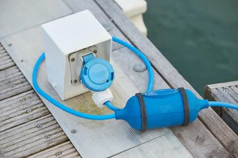 Electrical power socket bollard on pier. Stock Photos