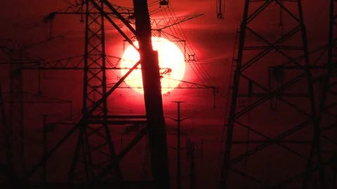 Electrical power transmission grid with red sunset and power lines Video stock 149384645