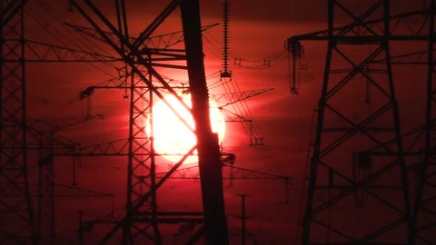 Electrical power transmission grid with red sunset and power lines Stock Footage 149384727