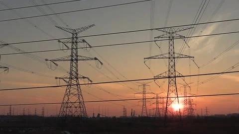 Electrical power transmission grid with red sunset and power lines Stock Footage 149384804