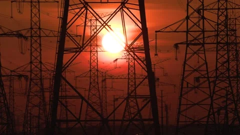 Electrical power transmission grid with red sunset and power lines Stock Footage 149384905
