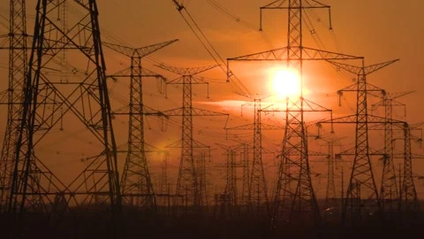 Electrical power transmission grid with red sunset and power lines Stock Footage 149385194