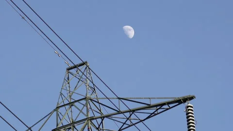 Electrical pylon with rising moon in background Video stock 141628930