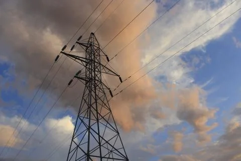 Electrical pylon Tower shot closeup with colorful clouds 库存照片