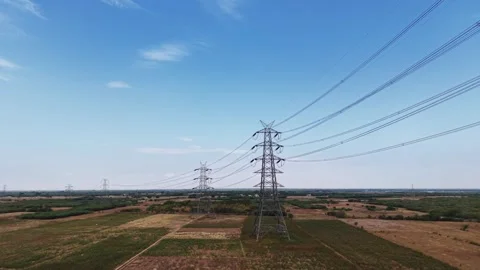 Electrical pylon transmission line crossing cultivated fields Stock Footage 340814168