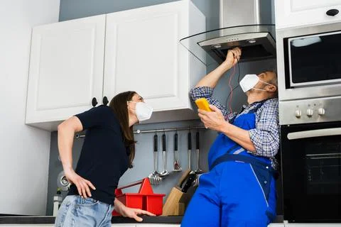 Electrical Repair In Air Check In Domestic Kitchen Stock Photos