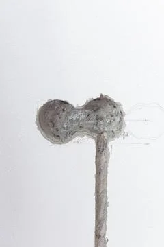 Electrical rough-in work is underway on a white apartment wall. An opening .. Stock Photos