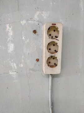 Electrical socket in grey wall Stock Photos